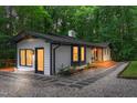 Beautiful home exterior showcasing the brick, siding, and inviting front entrance with mature trees at 301 Lord Berkley Rd, Raleigh, NC 27610