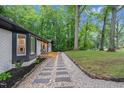 Exterior view of the walkway leading to the home with a manicured lawn at 301 Lord Berkley Rd, Raleigh, NC 27610
