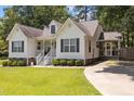 Lovely home with a well-kept lawn, traditional white siding, and a convenient screened-in porch at 304 Indigo Pl, Garner, NC 27529