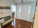 Welcoming foyer with hardwood floors, decorative lighting, and a view into the dining area at 304 Indigo Pl, Garner, NC 27529