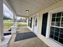 Covered front porch showcases classic columns, black railings, and access to the front door at 307 N Church St, Kenly, NC 27542