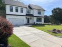 Beautiful two-story home boasting a spacious driveway and lush green lawn at 3204 Overlook Ct, Burlington, NC 27215