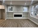 Spacious living room featuring a modern fireplace and built-in bookshelves at 3204 Overlook Ct, Burlington, NC 27215
