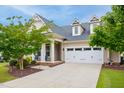 Charming home with a two-car garage and beautiful landscaping at 33 Village Walk Dr, Chapel Hill, NC 27517