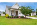 Charming home with a two-car garage, front porch and inviting landscaping at 33 Village Walk Dr, Chapel Hill, NC 27517