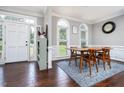 Formal dining room with hardwood floors, a modern table, and an exterior access door at 3901 Phlox Rd, Raleigh, NC 27616