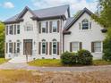 Charming two-story painted brick home with manicured landscaping and a paved entryway at 3901 Phlox Rd, Raleigh, NC 27616