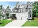 Beautiful two-story home with stone and siding, showcasing a well-maintained lawn and a two-car garage at 4104 Green Chase Way, Apex, NC 27539