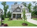 Charming two-story home featuring stone accents, a covered porch, and a lush green lawn at 4104 Green Chase Way, Apex, NC 27539