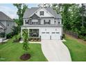 Attractive two-story home with stone detailing, a welcoming front porch, and a well-kept lawn at 4104 Green Chase Way, Apex, NC 27539