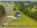High angle showcasing a home, fenced in backyard, and a long driveway on a large lot at 416 Fred Tew Rd, Dunn, NC 28334