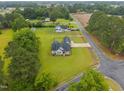 Aerial view of a home with a dark roof, surrounded by a large, green manicured lawn at 416 Fred Tew Rd, Dunn, NC 28334