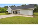View of the exterior elevation showcasing a covered parking and white garage door at 416 Fred Tew Rd, Dunn, NC 28334