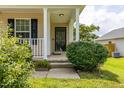 Inviting front porch with classic columns and lush landscaping at 418 Lodestone Dr, Durham, NC 27703