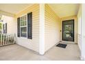 Covered front porch featuring neutral siding and a classic front door at 418 Lodestone Dr, Durham, NC 27703