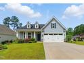 Lovely one-story home with light blue siding, dormer windows, and a two-car garage on a sunny day at 45 Glen Bend Ct, Spring Lake, NC 28390