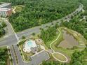 An aerial view of a beautiful community featuring a pool, clubhouse, walking path, and nearby amenities at 515 Historic Dr, Hillsborough, NC 27278