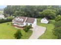 Charming two-story home with a rocking chair front porch, mature landscaping, and a detached garage at 541 Mallie Pearce Rd, Zebulon, NC 27597