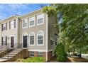 Exterior shot of a townhome with a charming architectural style and mature trees at 5545 Crabtree Park Ct, Raleigh, NC 27612