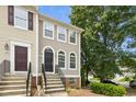 Lovely townhome exterior with brick foundation, arched windows and a well-kept front yard at 5545 Crabtree Park Ct, Raleigh, NC 27612