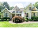 Attractive stone and siding home with landscaped front yard and American flag at 5920 Two Pines Trl, Wake Forest, NC 27587