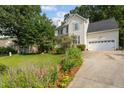 Charming two-story home featuring manicured landscaping and a welcoming front entrance and attached garage at 603 Everglades Dr, Mebane, NC 27302