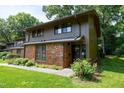 Townhome exterior with a brick facade and green lawn at 606 Oak Tree Dr, Chapel Hill, NC 27517