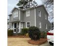 Charming two-story home with gray siding, white trim, and manicured landscaping at 627 New Road, Raleigh, NC 27608