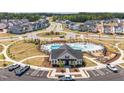 An inviting community with a pool, clubhouse, roundabout and well-maintained landscaping at 709 Emerald Bay Cir # 833, Raleigh, NC 27610