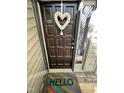 Inviting front door with a heart-shaped wreath and a colorful 'Hello' welcome mat at 80 Stoneridge Rd, Durham, NC 27705
