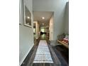 Bright hallway featuring wood floors, a mirror, decor, and glimpses of the connected rooms at 80 Stoneridge Rd, Durham, NC 27705