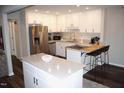 Updated kitchen featuring stainless steel appliances, white cabinets, and a stylish center island with bar seating at 80 Stoneridge Rd, Durham, NC 27705