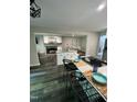 Open kitchen and living room with modern appliances, island seating, and fireplace at 80 Stoneridge Rd, Durham, NC 27705