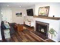 Bright living room with a modern fireplace, sleek hardwood floors, and stylish decor at 80 Stoneridge Rd, Durham, NC 27705