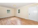 Bright living room with neutral walls, wood-look floors, and plenty of natural light at 919 Chester St, Durham, NC 27701