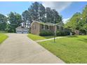 View of a brick home with a detached two car garage and plenty of driveway parking at 112 Saddletree Rd, Oxford, NC 27565