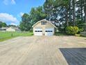 A spacious two-car garage with a wide driveway, offering ample parking and storage at 112 Saddletree Rd, Oxford, NC 27565