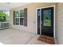 Welcoming front porch with a decorative glass door and a 'Welcome friends & Gathering' doormat at 11612 Leesville Rd, Raleigh, NC 27613