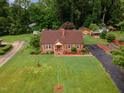 A captivating aerial view of a quaint home surrounded by lush greenery and a well-maintained yard at 132 Lord Ashley Rd, Raleigh, NC 27610