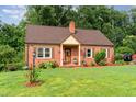 Inviting brick home with a well-kept lawn, small front porch, and charming curb appeal at 132 Lord Ashley Rd, Raleigh, NC 27610