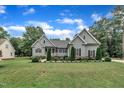 Inviting home features gray siding, manicured shrubs, and a well-kept lawn, creating a warm curb appeal at 152 Abundant Ave, Angier, NC 27501