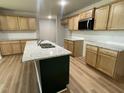 Bright kitchen with granite countertops, stainless steel appliances, and wood cabinets at 168 Oakfield Trace Dr, Four Oaks, NC 27524