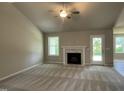 Spacious living room with a fireplace and large windows for natural light at 168 Oakfield Trace Dr, Four Oaks, NC 27524