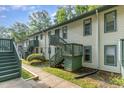 Two-story condo building with light-colored siding and green trim with wood stairs at 205 Ashley Forest Rd # Bldg D, Chapel Hill, NC 27514