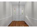 Inviting entryway with hardwood floors, neutral walls, and a solid front door with sidelights at 211 Forestview Dr, Elon, NC 27244