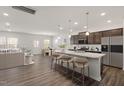Spacious open-concept kitchen featuring a large island, stainless steel appliances, and stylish pendant lighting at 3205 Pelican Ln, Durham, NC 27703