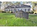 Charming single-story home featuring lush landscaping and a prominent address sign at 322 Gravley Dr, Rocky Mount, NC 27804