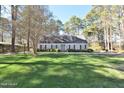 Inviting home with a well-manicured lawn, mature trees, and charming exterior, creating a serene curb appeal at 322 Gravley Dr, Rocky Mount, NC 27804