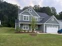 Charming two-story home with lush green lawn at 325 Olde Liberty Dr, Youngsville, NC 27596