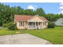 Well-kept single-story home with a spacious front yard and inviting curb appeal at 34 Scotts Creek Run, Angier, NC 27501